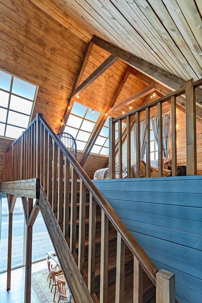 Wood paneled cabin with open stairway