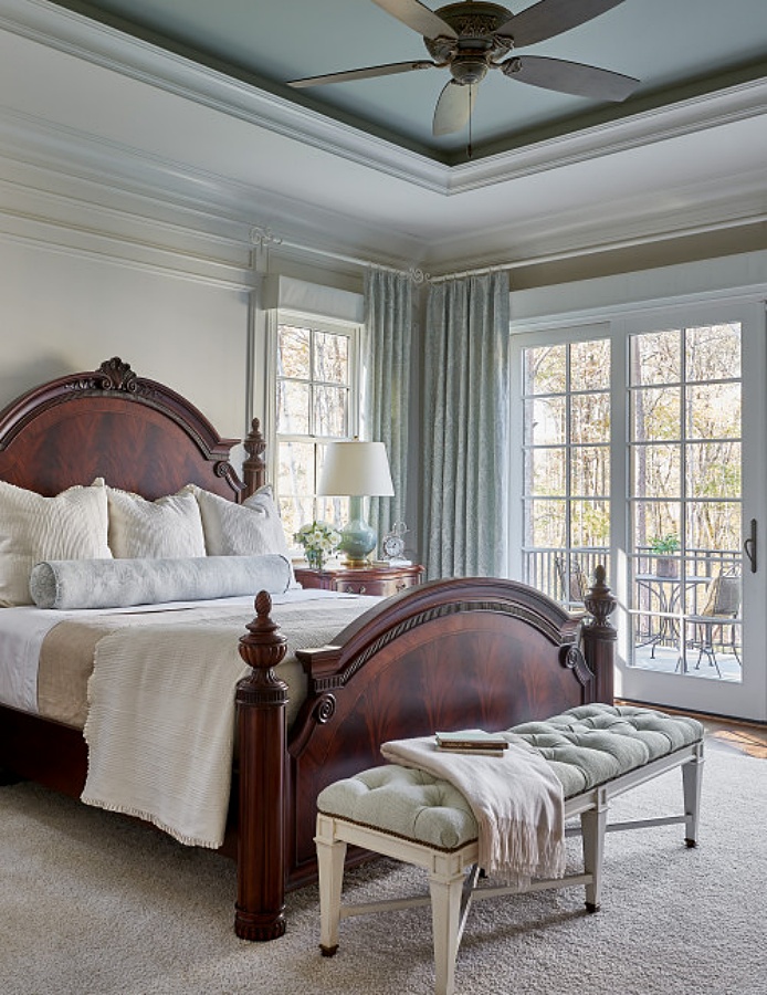 Gorgeous traditional master bedroom with French doors and balcony
