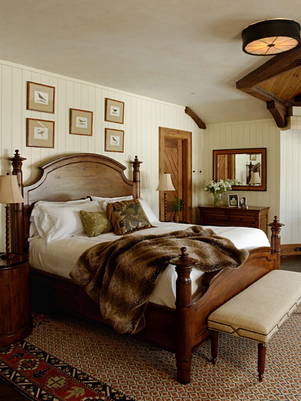 Wood bed in cozy bedrooms with faux fur throw and patterned rug