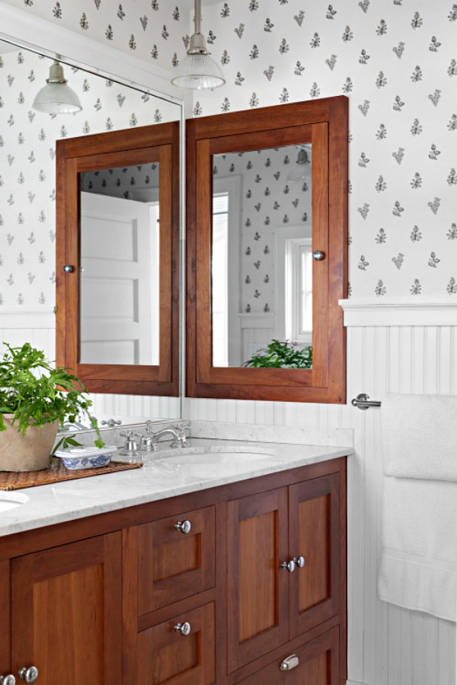 beach style bathroom with wood vanity and mirror