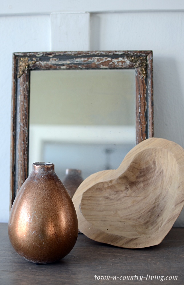 Brass vase, vintage mirror, and wooden heart bowl