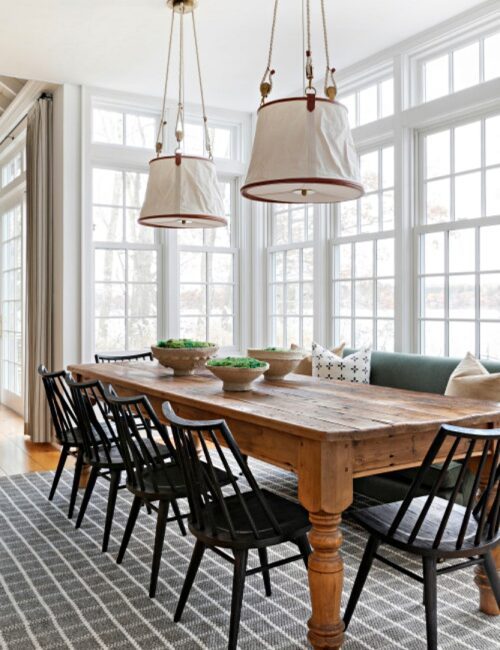 country style lakehouse dining room with expansive windows