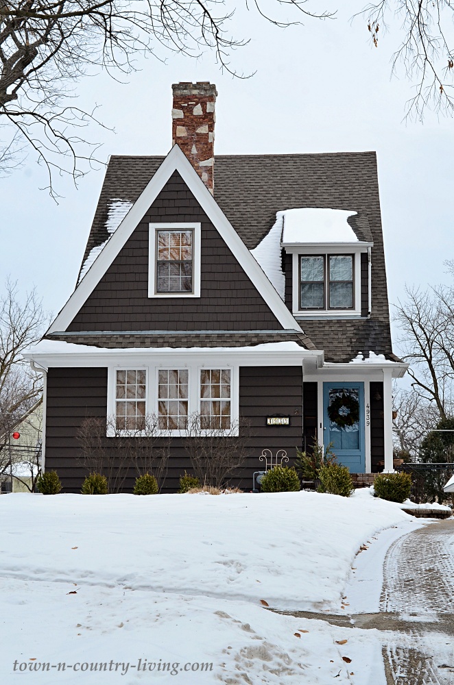 Dark gray bungalow with light blue door in Downers Grove