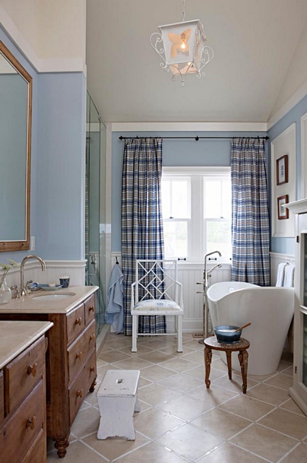 Pale blue bathroom with walk-in shower and freestanding tub