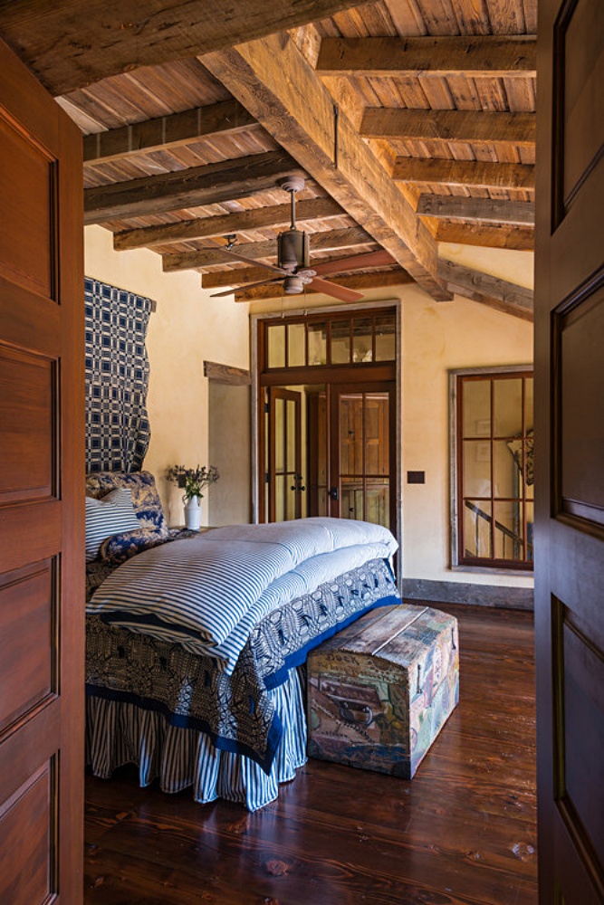 Blue and white bedding in rustic bedroom