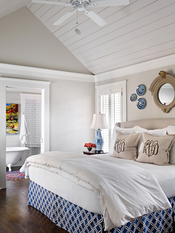 Traditional blue and white bedroom with vaulted white wood ceiling