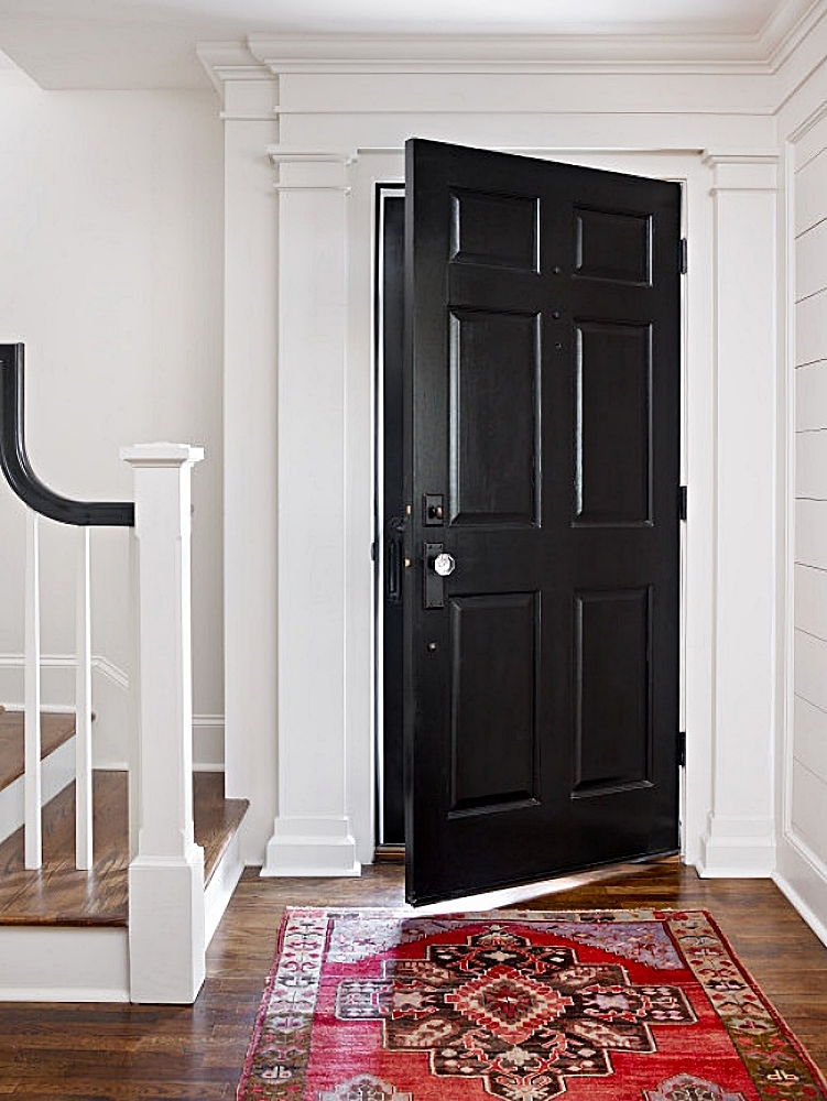 traditional entryway with black front door