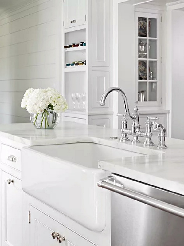 White kitchen with apron sink and silver gooseneck faucet