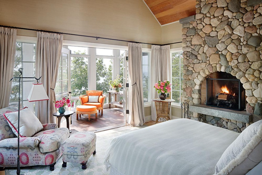 English style country bedroom with boulder stone fireplace