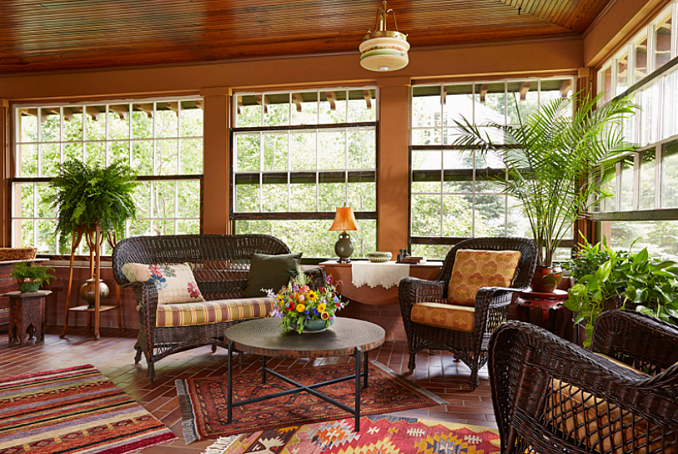Brown wicker furniture in enclosed four-season porch