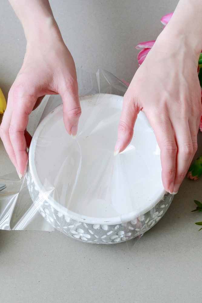 lining bowl with cellophane for a spring tulip arrangement