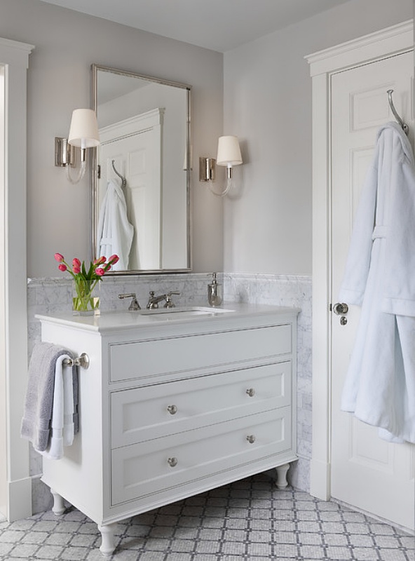White vanity in a pale gray bathroom