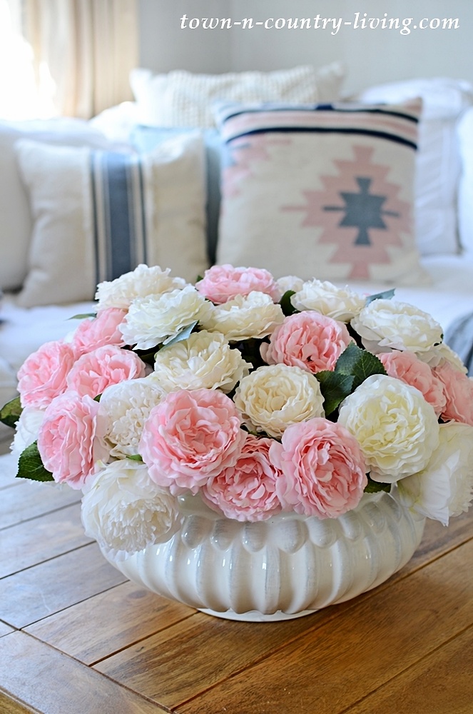 White bowl of pink and white flowers