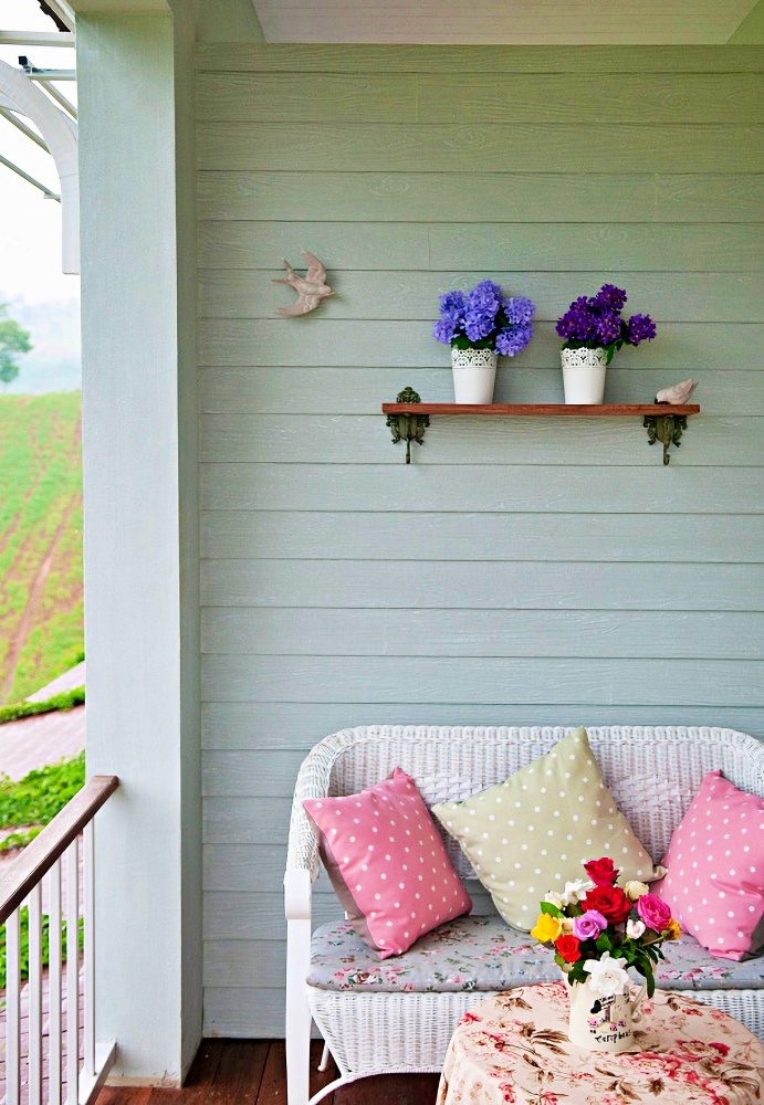 Cottage Porch with White Wicker Love Seat