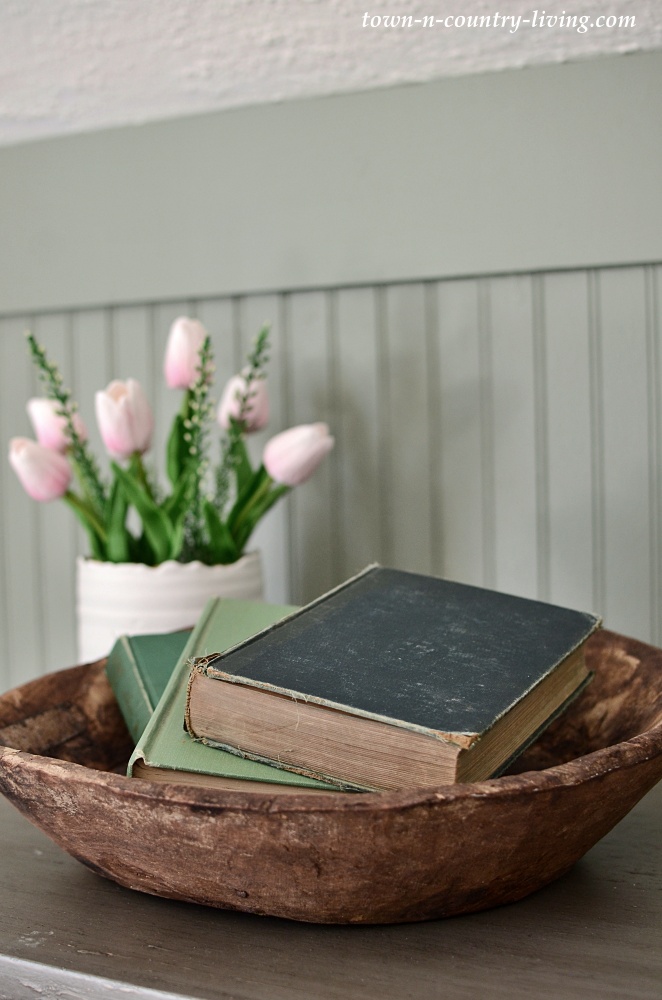 Wooden bowl with vintage books