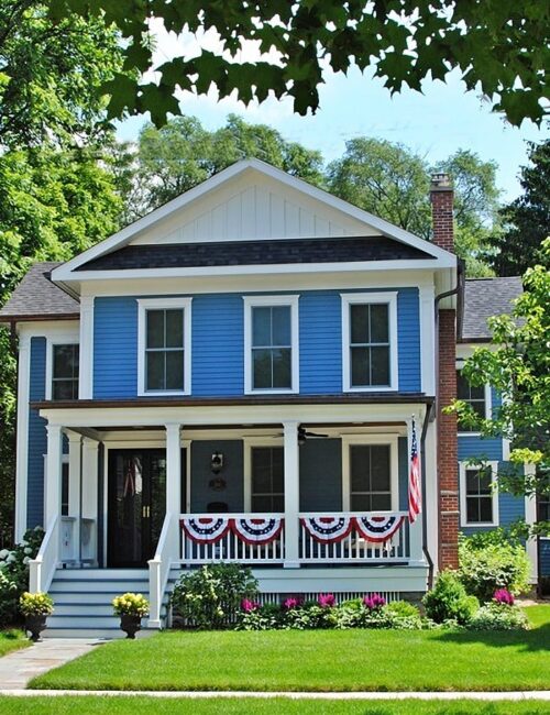 Blue farmhouse with full porch in Wheaton, IL
