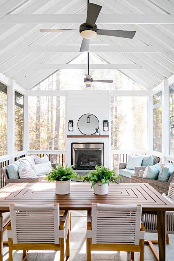White screened porch with vaulted ceiling and fireplace
