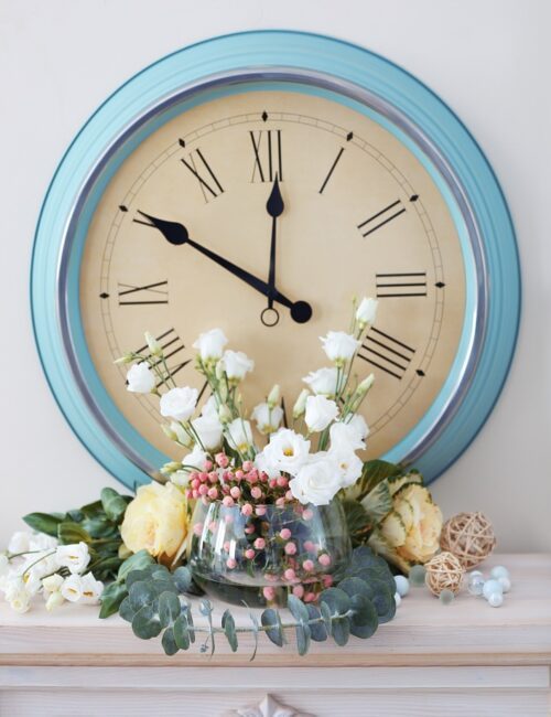 Powder blue wall clock on mantel