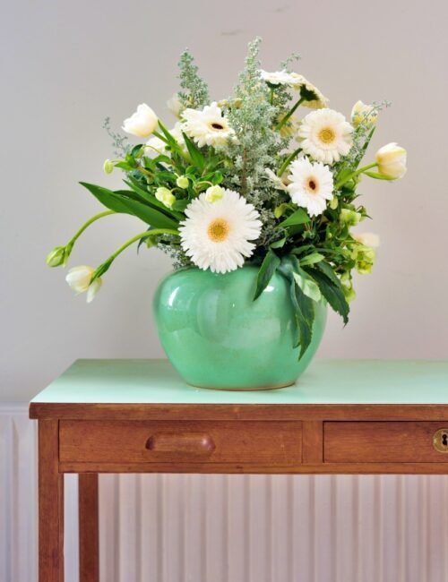 Spring bouquet of Gerbera daisies in green vase