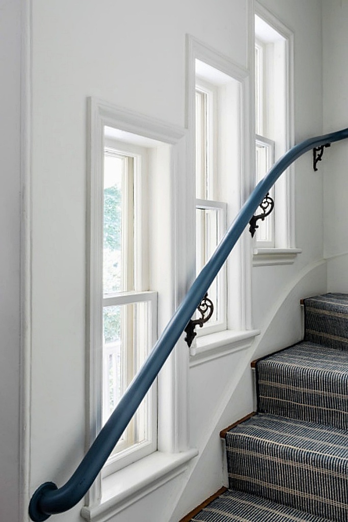 staircase with painted banister
