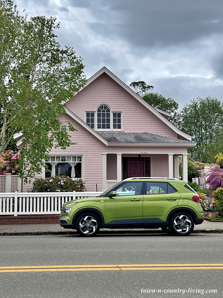 Pink bungalow with lime green car
