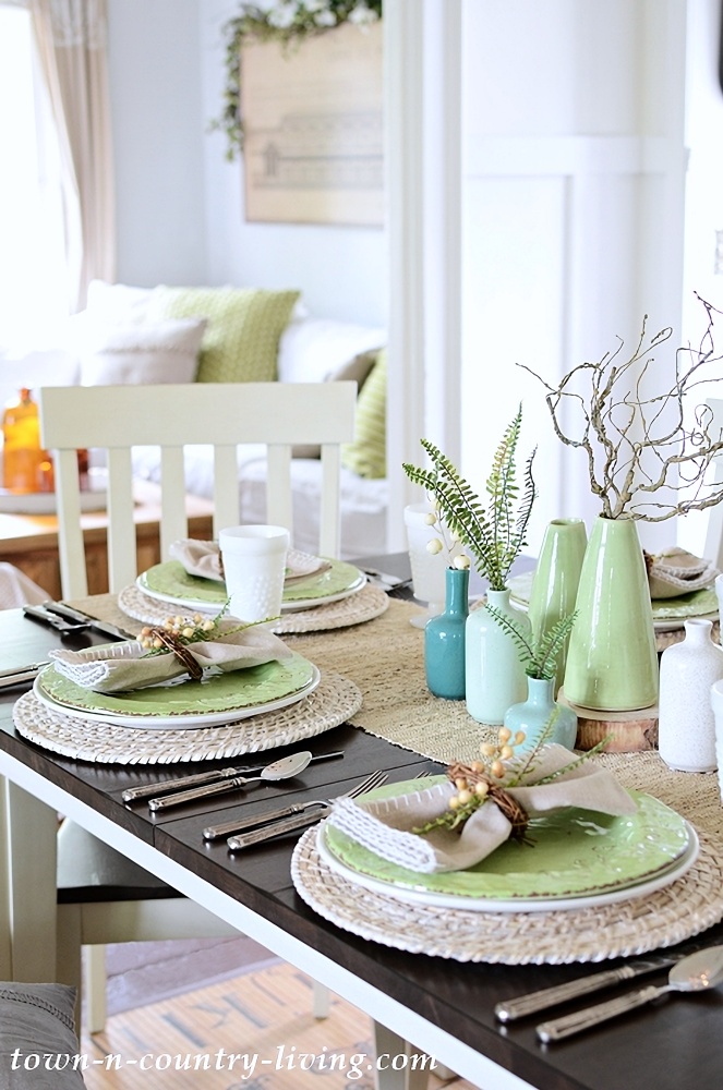 Summer table setting with pastel blue and green vases
