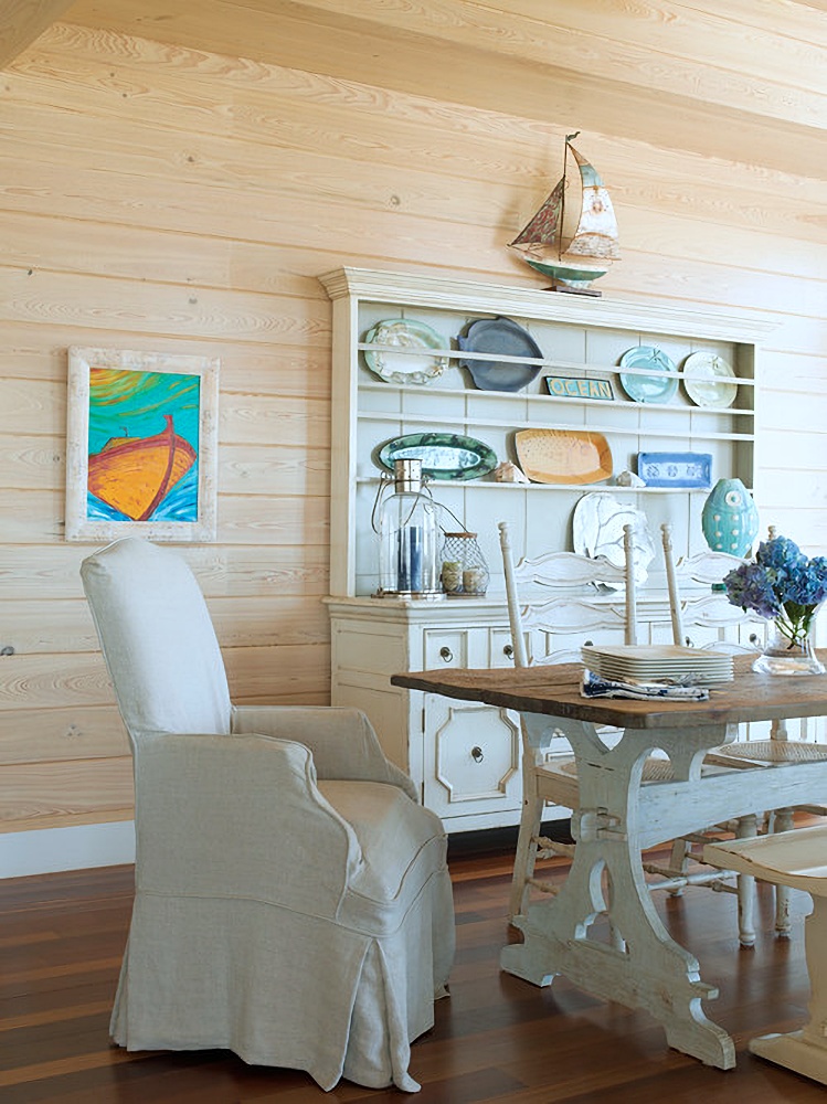 Cottage dining room with light wood horizontal paneling