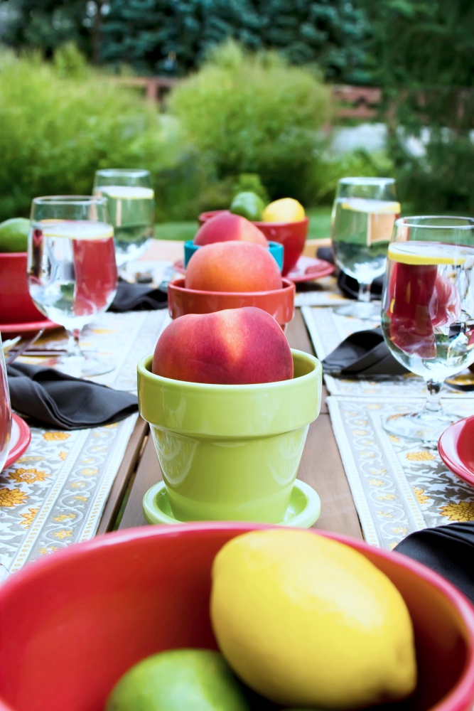 Outdoor place setting with peach centerpieces