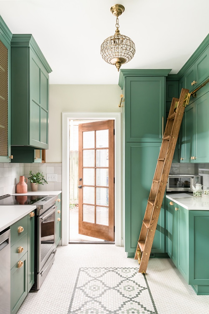 Small green and white kitchen with library ladder