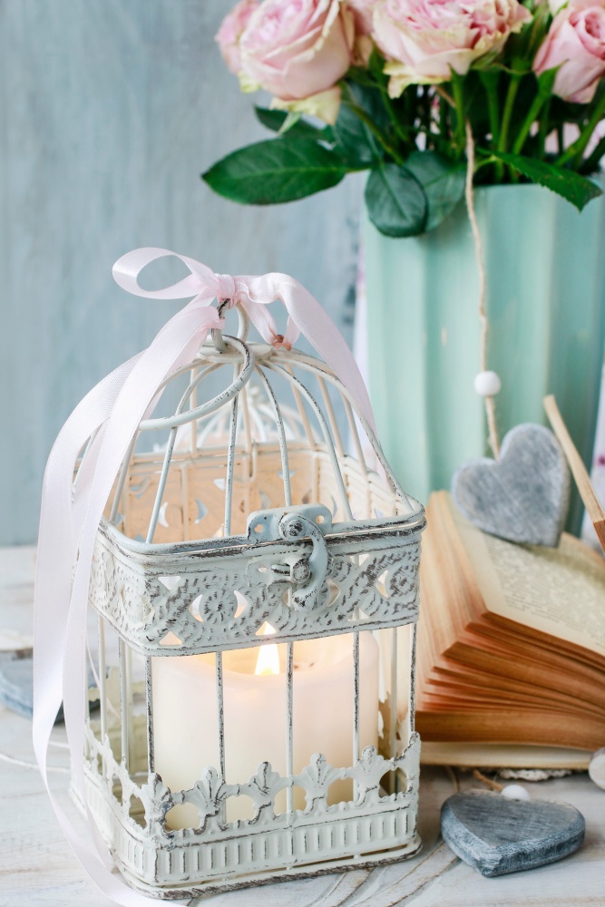 Table decoration with flowers and white vintage candle lantern