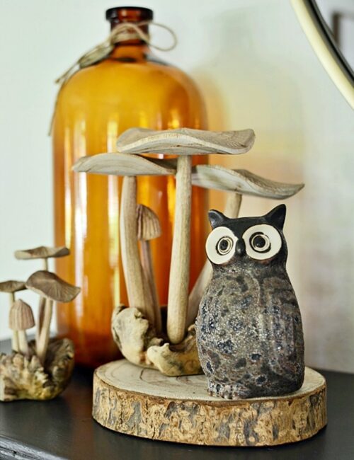 wooden mushrooms and owl on living room mantel