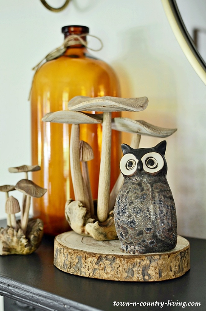 wooden mushrooms and owl on living room mantel