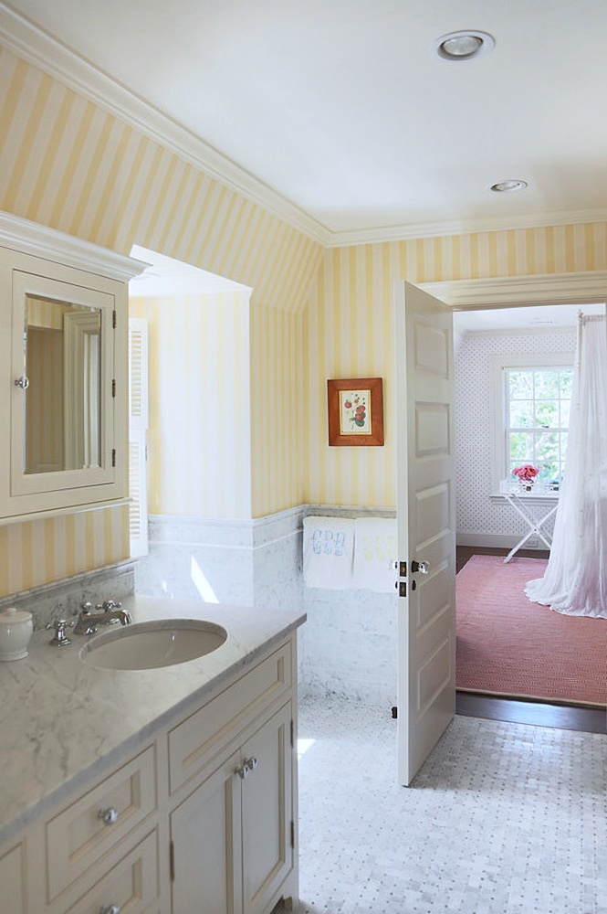 Yellow and white bathroom with striped wallpaper