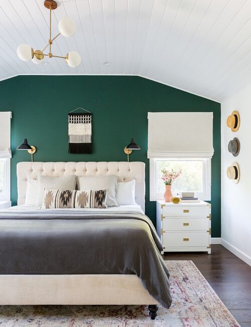 white bedroom with dark green accent wall