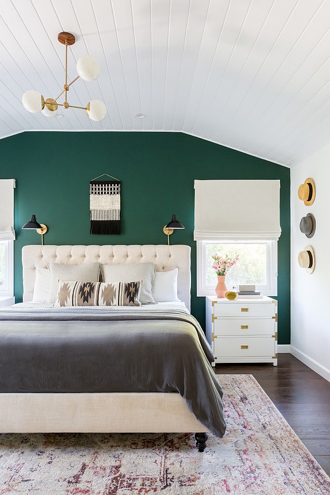 white bedroom with dark green accent wall