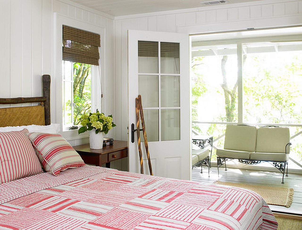 Red and white rustic bedroom in renovated lake cottage