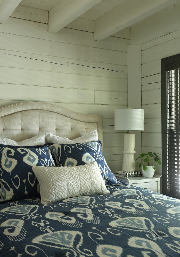 navy geometric print bedspread in renovated log cabin home