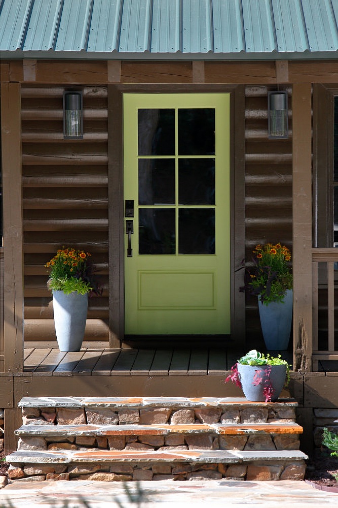 Light green door on log cabin porch