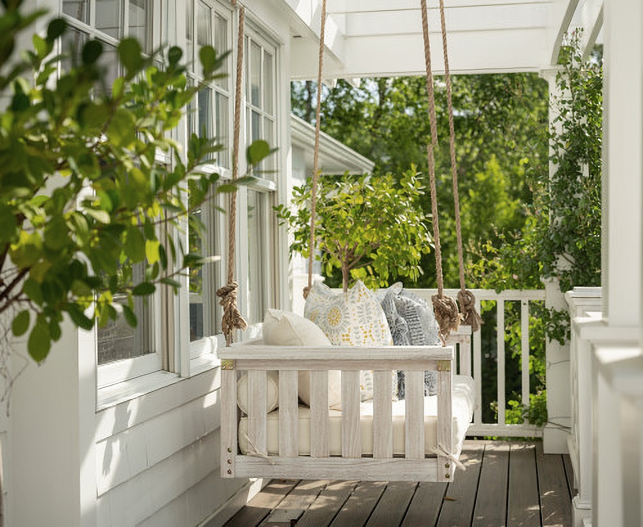 Large porch swing on white house