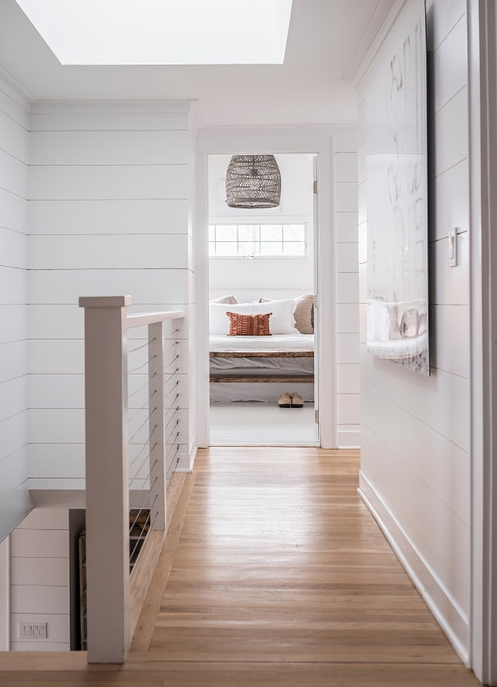 Light and airy hallway with white shiplap walls