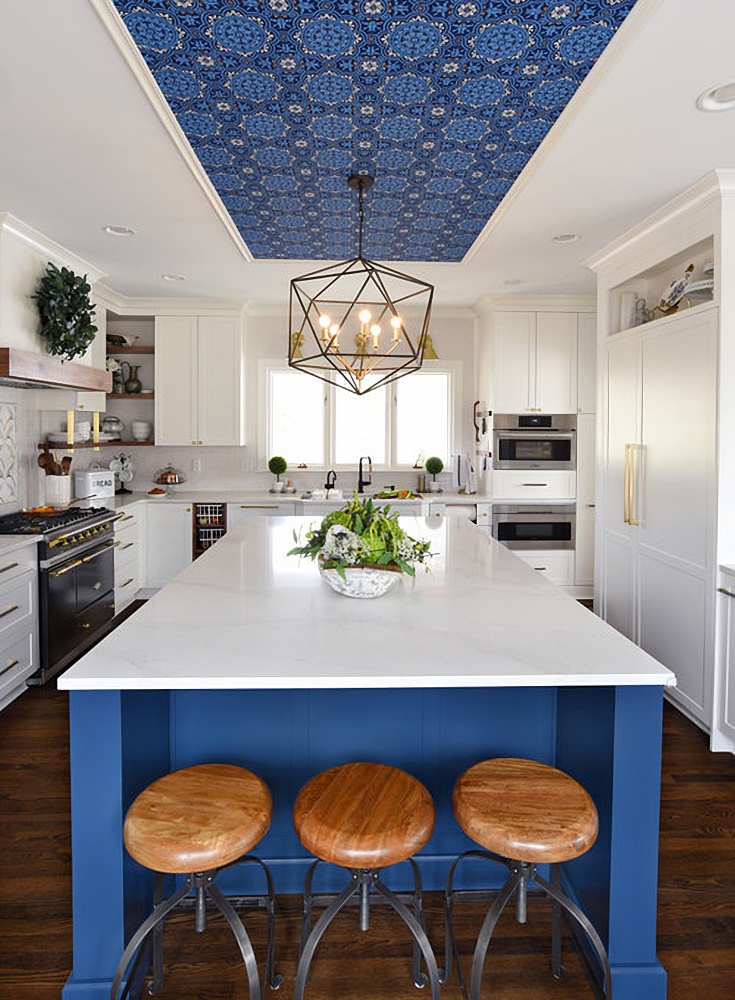 blue and white kitchen with wallpapered ceiling space
