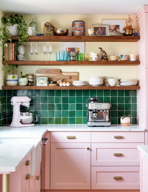 Pink kitchen cabinets with rich green tile back splash