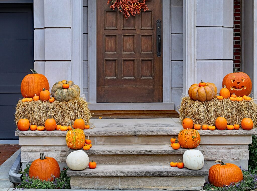 Pumpkins and hay bales on the front porch - fall decorating