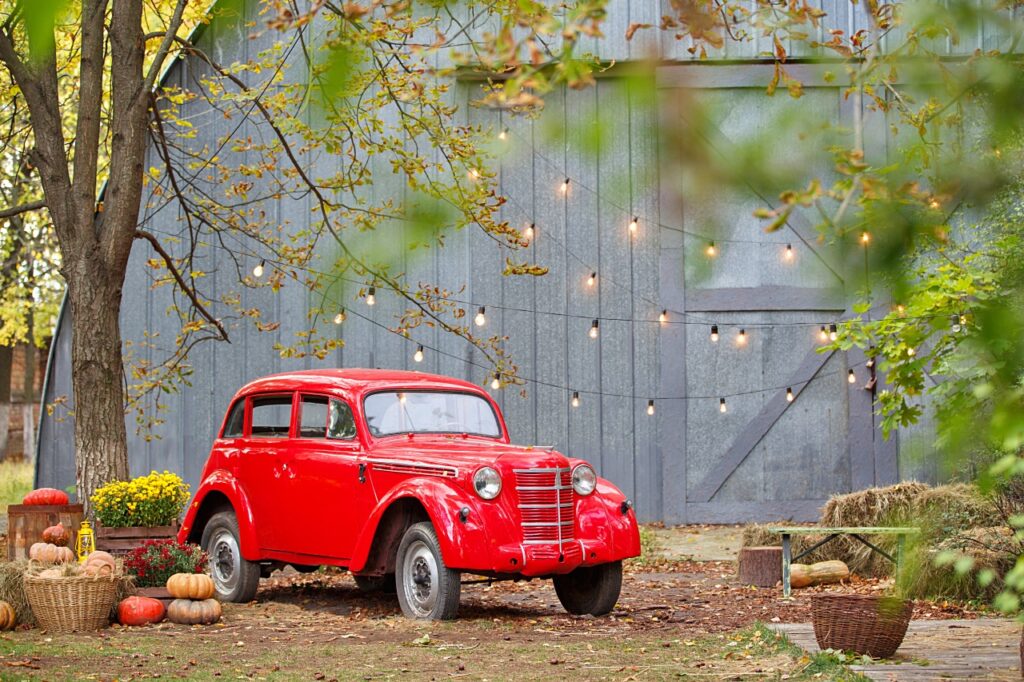 Outdoor fall decorations with red retro car