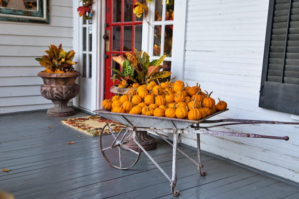 White And Grey Porch with Fall Pumpkin Decor By Red Door