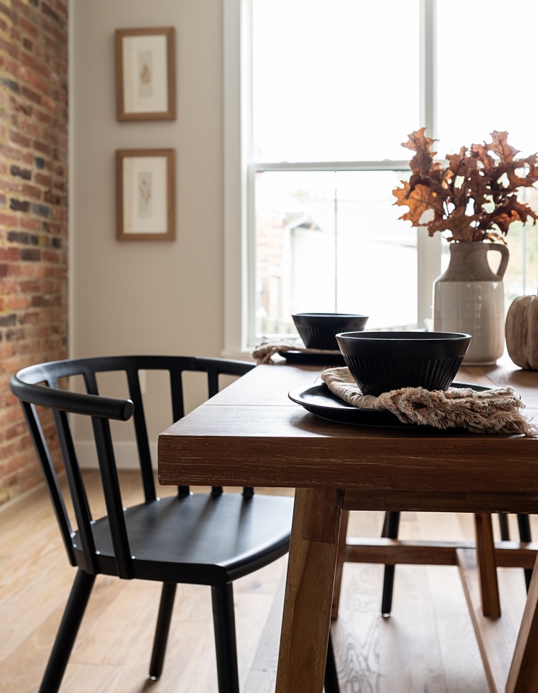 Black Windsor chair with wood table in small dining room