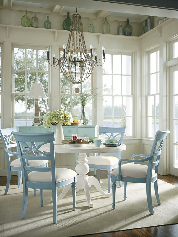 Blue and white beach style dining room with views of the water