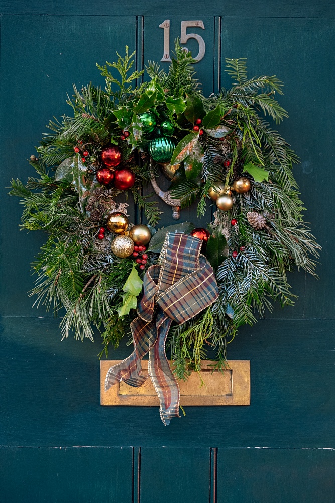 Natural Christmas wreath on a dark blue door