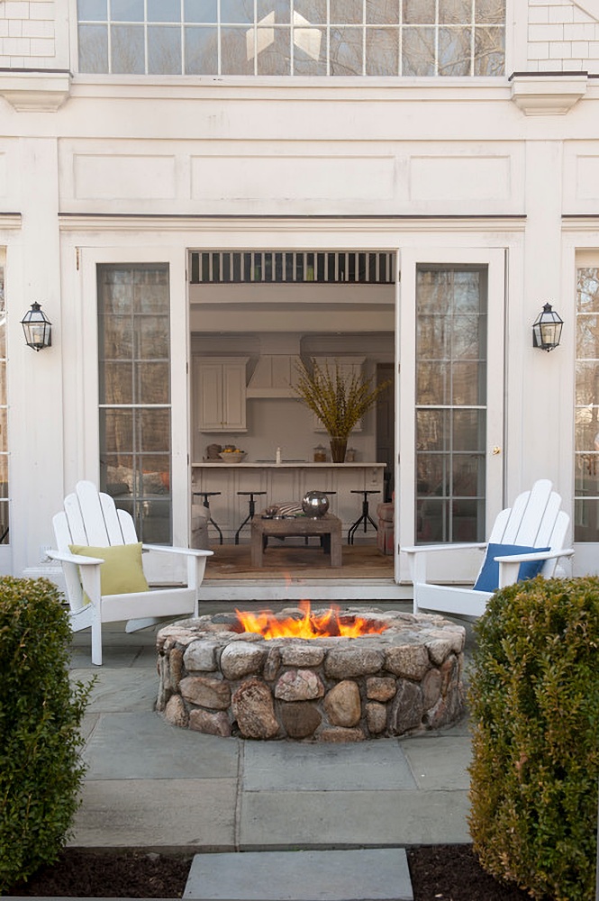 patio with stone firepit and Adirondack chairs