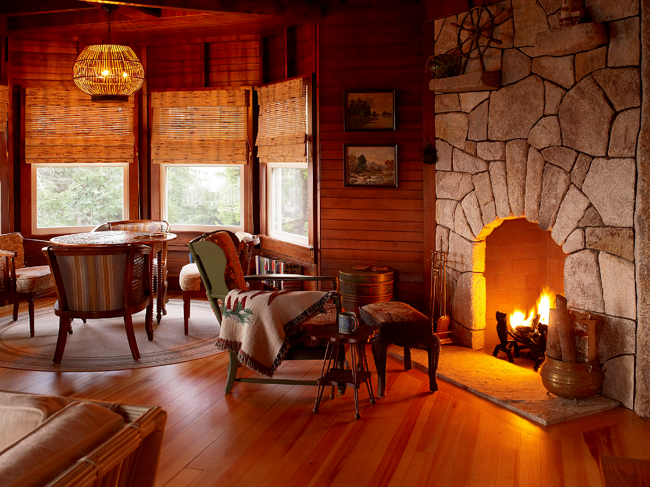 Cabin style living room with stone fireplace in a Maine bunk house